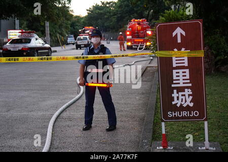 Naha, Japan. 31st Oct, 2019. A police officer standing behind the limit line at the Shurijo castle, a UNESCO World Heritage site. Fire broke out around midnight and burned down the main hall of the castle. Credit: SOPA Images Limited/Alamy Live News