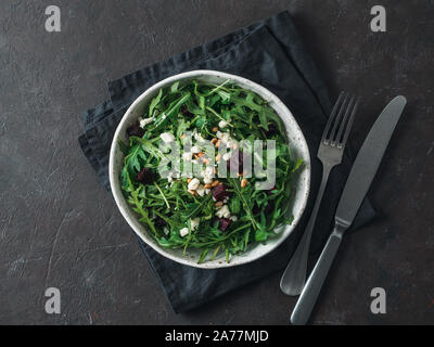 Beetroot, aragula and soft cheese salad over black background. Top view or flat lay. Copy space for text. Idea and recipe for healthy vegetarian salad. Clean eating diet concept Stock Photo