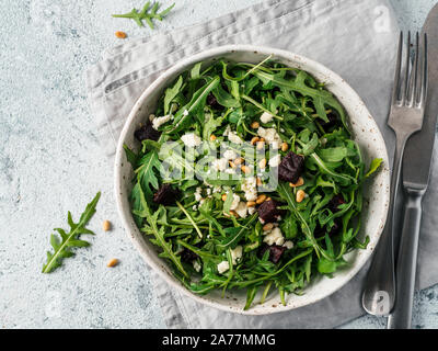 Beetroot, aragula and soft cheese salad over gray background. Top view or flat lay. Copy space for text. Idea and recipe for healthy vegetarian summer salad. Clean eating diet concept Stock Photo
