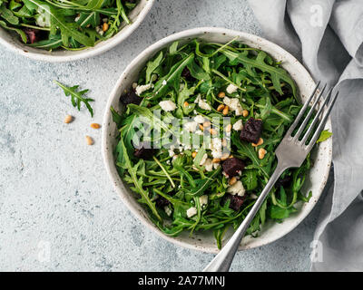 Beetroot, aragula and soft cheese salad over gray background. Top view or flat lay. Copy space for text. Idea and recipe for healthy vegetarian summer salad. Clean eating diet concept Stock Photo