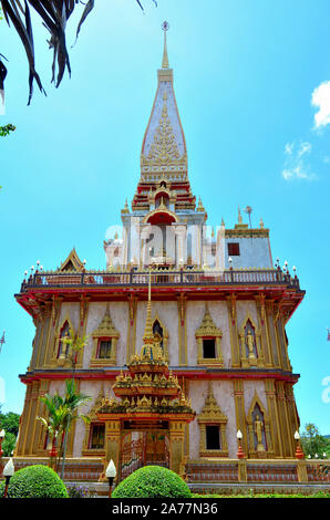 A view of the chedi betwen two palm trees at Chalong Temple Phuket Thailand