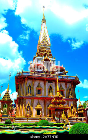 A very colourful temple with the sky and clouds to the back at Chalong Temple Phuket Thailand