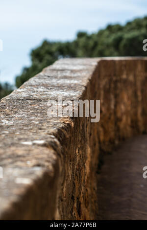 Stone fence on a medieval path in Italy Stock Photo