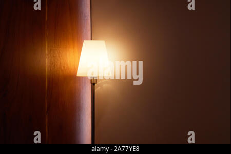 Floor lamp illuminating, in the corner of living room Stock Photo
