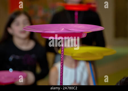 Fun with Spinning Plates .balancing a spinning plate. A collection of spinning purple plates . Stock Photo