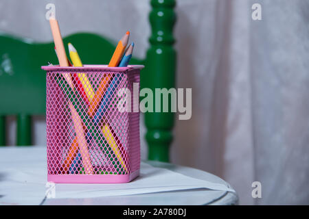Colored pencils in a pencil case on white background . Color pencils in pink case on white background isolated . Creative concept shot of colorful Stock Photo