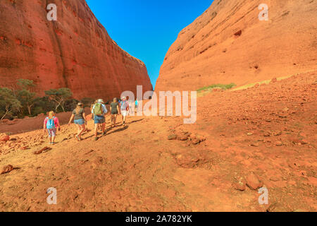 Uluru, Northern Territory, Australia - Aug 24, 2019: many people walking towards two tallest domes of Walpa Gorge entrance in Uluru-Kata Tjuta Stock Photo