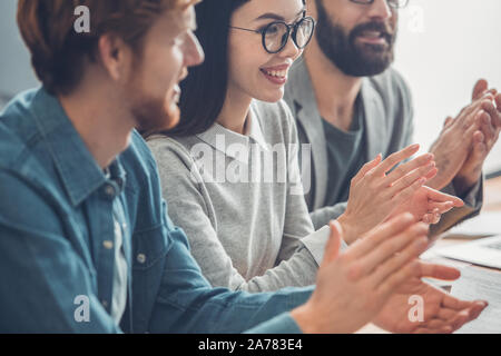 Startupers working together at office having business meeting clapping smiling cheerful close-up Stock Photo
