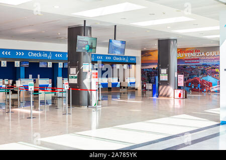 Trieste, Italy - 09-15-2019: Entrance of the Trieste Airport with the departure gates, security control, shops and luggage claim. Stock Photo