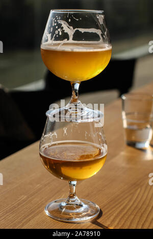 Two snifter glass with beer one on top of the other Stock Photo