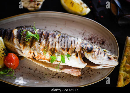 delicious grilled fish with lemon, salt & pepper Stock Photo