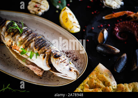 delicious grilled fish with lemon, salt & pepper Stock Photo