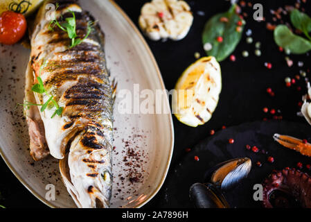delicious grilled fish with lemon, salt & pepper Stock Photo
