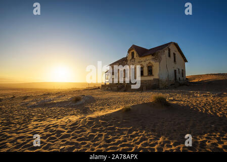 Sunrise above an abandoned house in Kolmanskop ghost town, Namibia Stock Photo