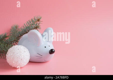 Chinese Zodiac Sign Year of Rat. Little rat as money box and white ball, branches on pink background. Symbol of 2020 with space for text. Happy New Ye Stock Photo