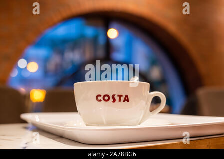 Chengdu, Sichuan province, China - Oct 26, 2019 : Coffee cup on a table with an arch window in the background at Costa Coffee downtown Chengdu Stock Photo