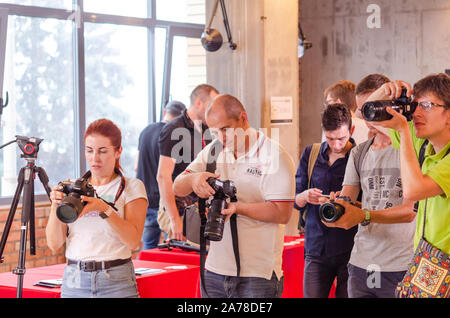 A group photographers at an event shooting a report using a digital cameras. Stock Photo