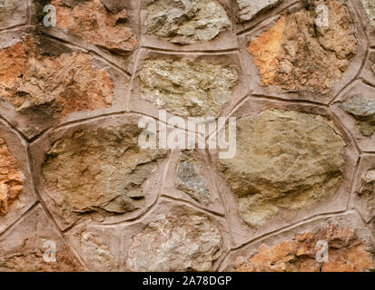 Mountain chalet wall made from natural river stone and cement . Country rustic background Stock Photo