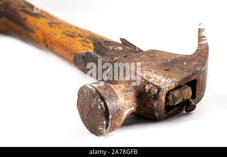 Old / classic Rusty hammer on a wood table Stock Photo