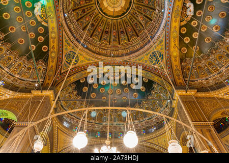 Ceiling of the great Mosque of Muhammad Ali Pasha - Alabaster Mosque - suited in the Citadel of Cairo, Egypt, with intersection of four domes decorated with green and golden floral patterns Stock Photo