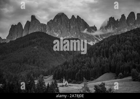 Dolomites, Italy - July, 2019: Famous best alpine place of the world, Santa Maddalena village with Dolomites mountains in background, Val di Funes val Stock Photo