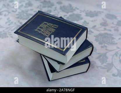 Several books of Torah are lying on the tablecloth. Stock Photo