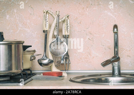 Different Kitchen Utensils - ladle, pan, etc. on the kitchen Stock Photo