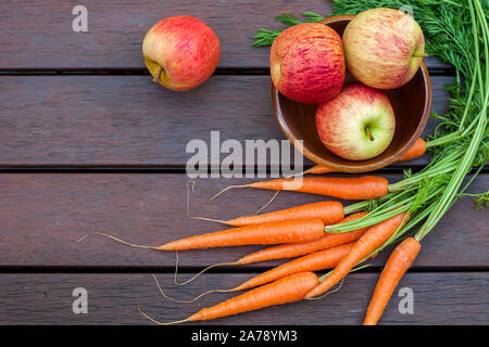Carrots and apples on the wood Stock Photo