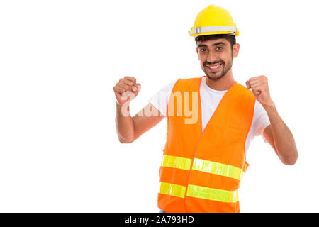 Young happy Persian man construction worker smiling while lookin Stock Photo