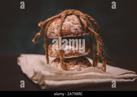 fresh gingerbread cookies tied with a rope on the table Stock Photo