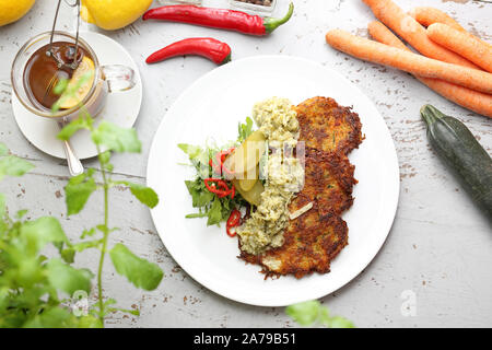 Vegetable fritters with potato, carrot, zucchini, onion. Fried vegetable pies Stock Photo