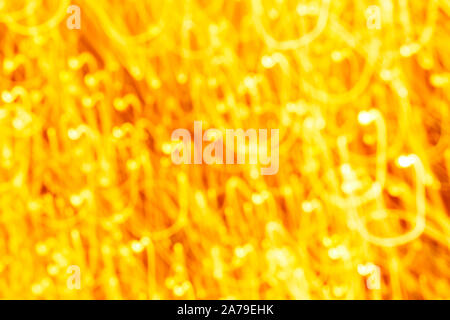 Futuristic blurred lights holiday monochrome background in yellow. Horizontal, soft focus Stock Photo