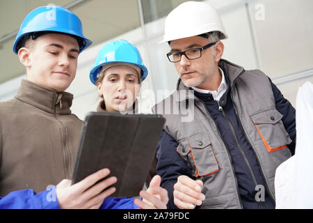 Instructor with young people in engineering training Stock Photo
