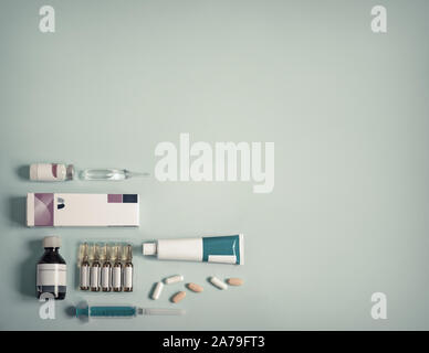 Different shapes of drugs on blue background Stock Photo