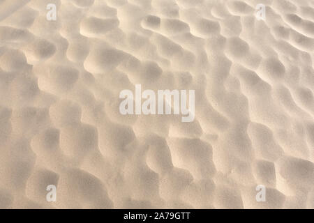 Hot fine dry desert sand with dimples as background top view close up Stock Photo