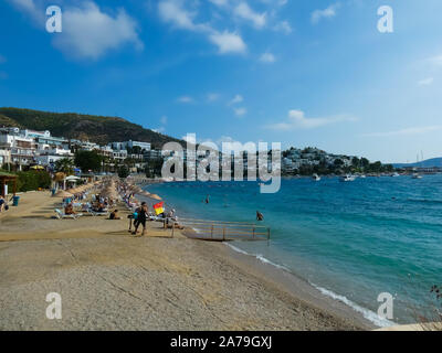 bodrum beach full of tourists and a blue sea on a hot summer day Stock Photo