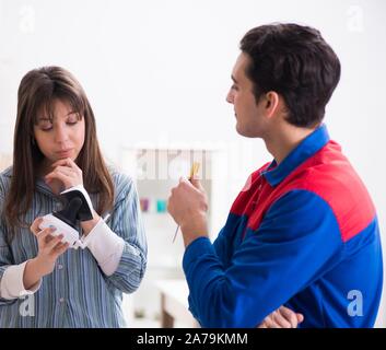 Client getting securty camera installed at home by contractor Stock Photo