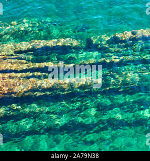 Water surface with ripple and rocky sea bottom from above - natural abstract background Stock Photo