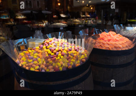 Huge display in wooden barrels of brightly coloured, sugary, sweets in a specialist sweet shop in Venice, Rome. Stock Photo