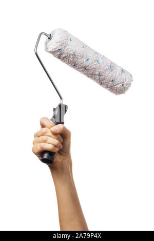 Womans hand raised up holds a roller for painting various surfaces. Worker with tool isolated on white background Stock Photo