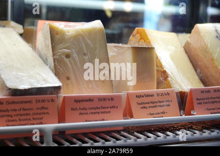 Boothbay Harbor, ME / USA - October 20, 2019: Various gourmet cheeses behind a glass display at Eventide Specialties Stock Photo
