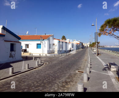 Typical southern seaside cityscape in Cyprus with street and white houses on bright sunny day in the off-season time in winter Stock Photo