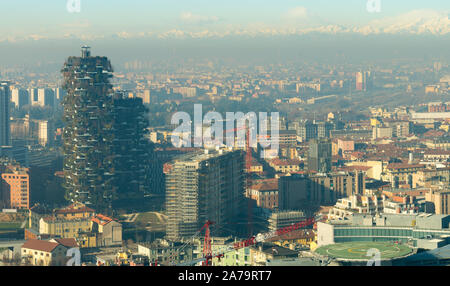 Milan skyline, aerial view of Bosco Verticale (Vertical forest) skyscrapers and the city covered by smog. Italian landscape. Stock Photo