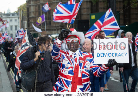 London, UK. 31st Oct, 2019. A Leave means Leave march has taken place at Westminster in protest at the failure to deliver Brexit. There wasa heavy police presence at the protest and arrests were made. Here Joseph Afrane waves a Union Jack. Credit: Clearpix/Alamy Live News Stock Photo