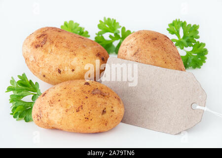 Potatoes on white  background with label Stock Photo