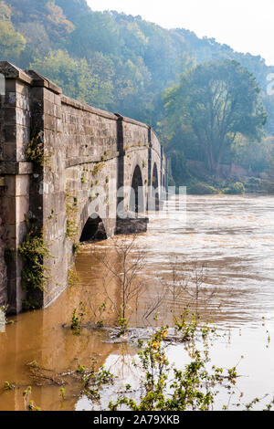 The muddy, silty waters of the River Wye in flood on 28.10.2019 flowing under Kerne Bridge, Herefordshire UK - Caused by heavy rain in Wales.