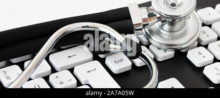 Keyboard with stehoscope on white background close up view Stock Photo