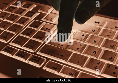 Keyboard with hand and light beams Stock Photo