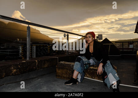 A model on the phone at the Old Castle Brewery in the South African Cape Town suburb of Woodstock, with the back drop of Table Mountain Stock Photo