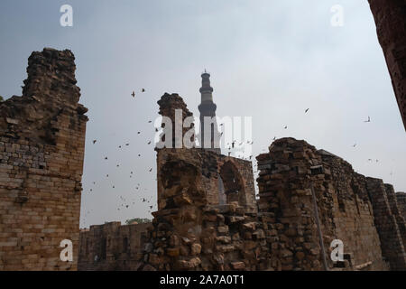 View of Qutub Minar againt the screen arches. Stock Photo